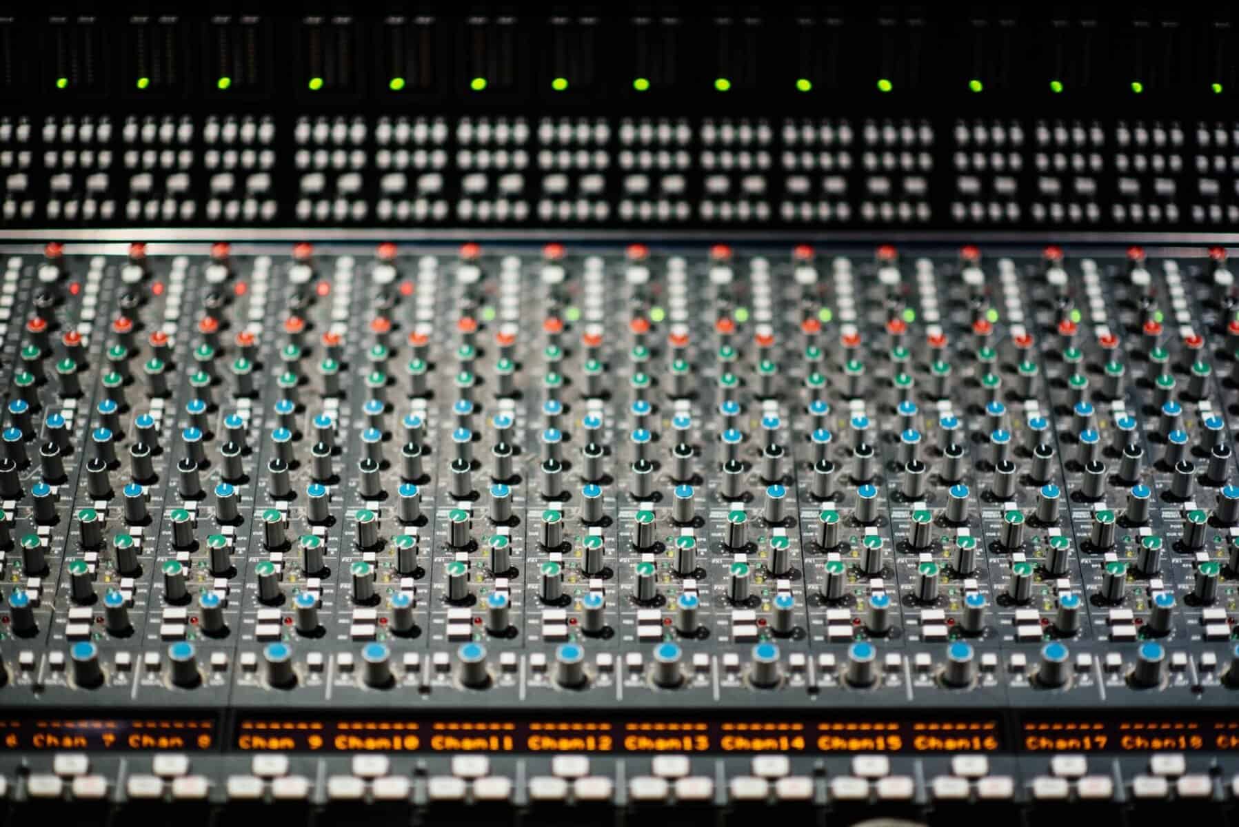 Audio mixing console with colorful knobs and sliders for professional sound engineering in Atlanta.