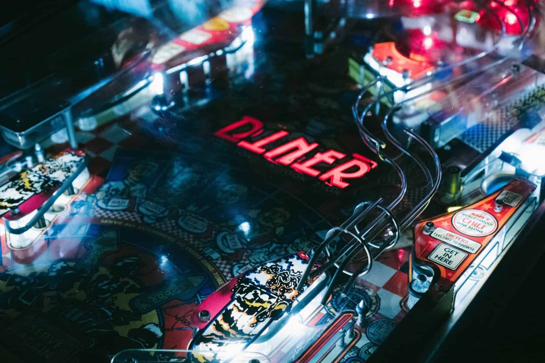 Colorful pinball machine with illuminated lights and intricate design for arcade entertainment.